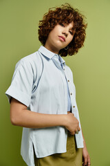 Young woman with curly hair shows off summer fashion against a lush green backdrop