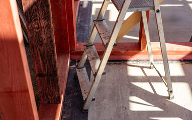 Under-construction residential wooden frame home located near a forest. Commencement of a new...