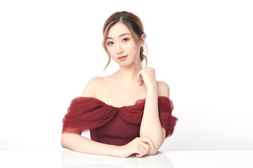 A beautiful young Asian woman with clean, fresh skin against a white background. Skincare, facial...