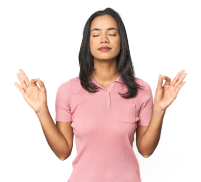 Simple portrait of a young Latina relaxes after hard working day, she is performing yoga.