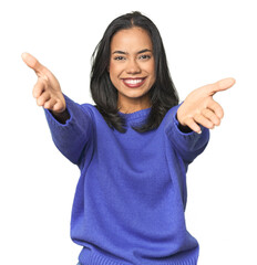 Simple portrait of a young Latina showing a welcome expression.