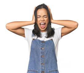 Simple portrait of a young Latina covering ears with hands trying not to hear too loud sound.