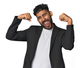 Hispanic businessman in suit in studio showing strength gesture with arms, symbol of feminine power
