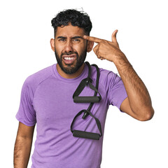 Hispanic male in sportswear with bands in studio showing a disappointment gesture with forefinger.