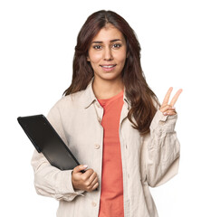 Middle Eastern woman with graphic tablet showing number two with fingers.