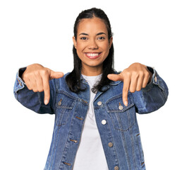 Young Filipina woman points down with fingers, positive feeling.