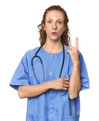 Redhead young caucasian  nurse in studio having some great idea, concept of creativity.