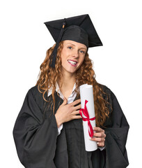 Graduate redhead with diploma laughs out loudly keeping hand on chest.