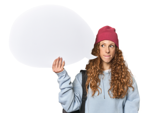 Redhead holding a comic speech bubble confused, feels doubtful and unsure.