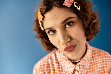 Young woman showcases vibrant summer fashion against a bold blue backdrop