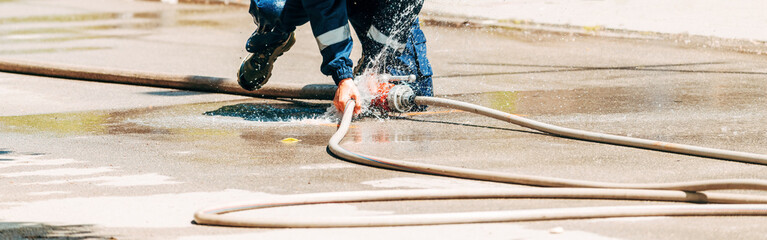 Firefighters attaching water hose on site