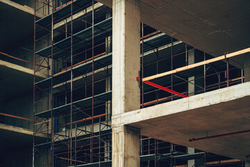 Low angle view of modern corporate office building construction site, concrete frame structure with...