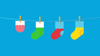 Three pairs of socks hanging on a line. The socks are of different colors and sizes. The image has a bright and cheerful mood, with the colors of the socks