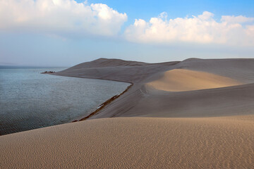 Doha, Qatar - June 10, 2025: Desert at sunrise, morning glow over dunes and inland sea of the...