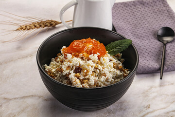 Curd with granola and orange jam