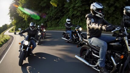 Bikers riding on country road at sunset