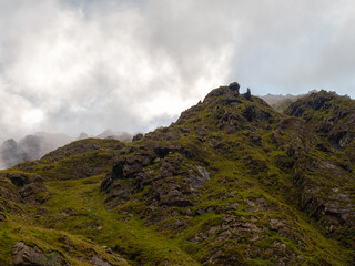 Viewing green landscape and rugged cliffs on the Carrauntoohill walkway, Ireland, during a cloudy...