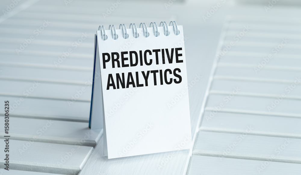 Poster a white spiral notebook with the word predictive analytics written on it