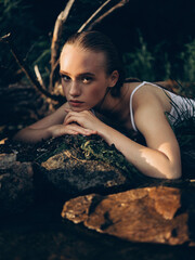Young Woman Resting by a Forest Stream on a Summer Day. © Stanislav