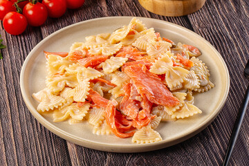 Italian pasta farfalle with salmon
