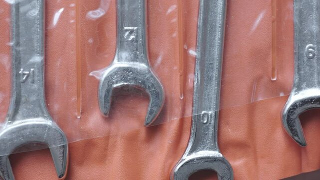 Close-up of wrenches in orange package in different sizes