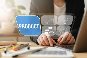 A person is typing on a laptop with a digital interface displaying product development icons on a wooden desk