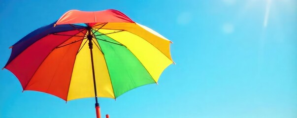 Vibrant Rainbow Umbrella Against a Sunny Blue Sky Joyful Summer Symbol