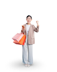 Full-length portrait of a smiling young Asian woman holding shopping bags and her smartphone while giving a thumbs-up, indicating approval for online shopping or a product.
