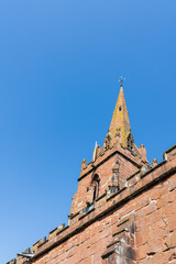 Church Steeple in portrait orientation, religious Christian building with a blue sky