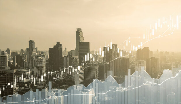 Photography of a Virtual financial stock market graph with upward trending lines and candlestick charts on the background of an urban skyline.