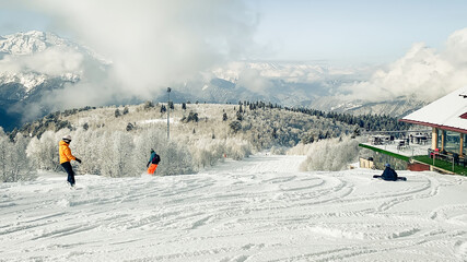 Sunlit ski slope after fresh snow fall at Hatsvali ski resort in Georgia. Clear blue sky, pine...