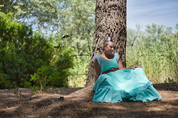 Young woman, beautiful, blonde, with typical Andalusian flamenco costume to go on pilgrimage in...