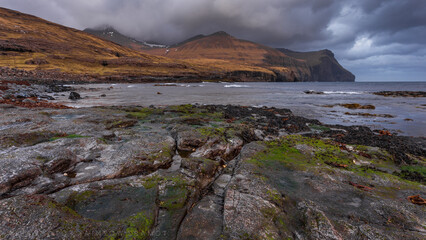 Faroe Islands waterfall M&uacute;lafossur near village Gasadalurron the Island V&aacute;gar. Green mountain caost landscape