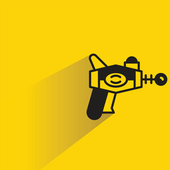 space gun with shadow on yellow background