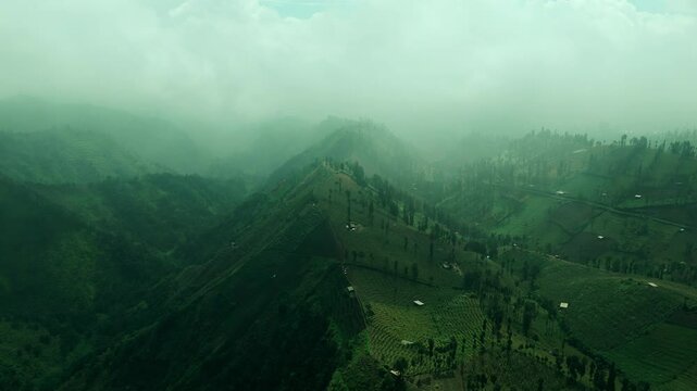 Aerial of Foggy Green Mountains in East Java, Indonesia