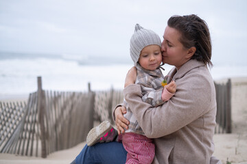 Portrait of mother and little daughter on the beach