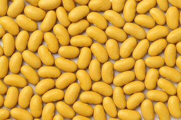 Bright yellow kidney bean with smooth texture on a plain white surface. Featuring a gentle sweetness and tender consistency. Nutritional benefits, vitamins, and wholesome eating options.