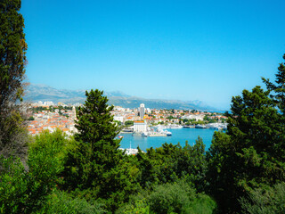 Breathtaking panoramic view from Marjan Hill in Split, Croatia, featuring the Adriatic Sea, vibrant rooftops, lush greenery, and a sunlit Mediterranean cityscape.
