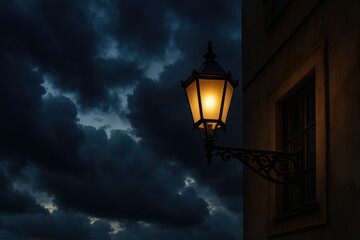 Antique street lamp under stormy skies illuminating the urban night