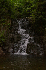 spectacular waterfall in the middle of the forest in summer