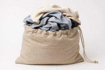 Drawstring linen bag filled with laundry against a white backdrop