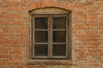 Vintage window set against aged brick wall
