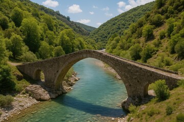 Fototapeta premium Ancient stone arch spanning a river in a historic region