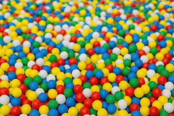 Colorful children's play area with many balls, blurred background