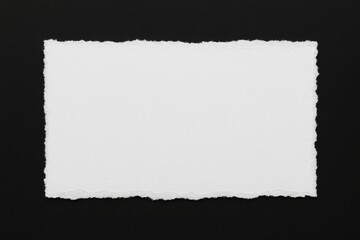 Obraz premium A fragment of torn paper on a dark background with empty space for text