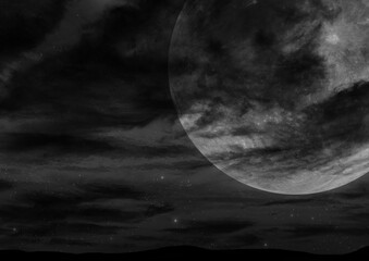 雲が出る満月の夜空モノクロ