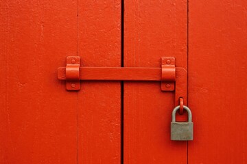 The wooden door lock features a vibrant red finish for enhanced durability.