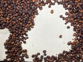 Dry brown coffee beans on white background