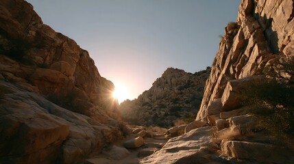 Obraz premium Desert Landscape with Sun Shining Between Rocks