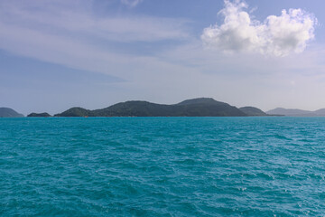 Obraz premium Turquoise blue waters and Lush green islands of the coast of Cape Panwa located on the eastern side of Phuket island in Thailand